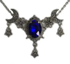 This is a new handmade necklace. It is made with antiqued silver plated filigrees, accented with a high quality DARK BLUE glass rhinestone. Decorated portion is 2 1/2" wide and 1 3/4" tall in the center. Necklace is adjustable 15-18" with a lobster clasp and chain extender. If you would like a different length, please send us a message. Gothic Blue Metal Jewelry, Blue Gothic Metal Necklace, Blue Gothic Metal Jewelry, Handmade Gothic Blue Necklace, Handmade Blue Gothic Necklace, Gothic Blue Jewelry For Gifts, Blue Gothic Jewelry For Gifts, Blue Gothic Jewelry For Gift, Diy Wire Jewelry Rings