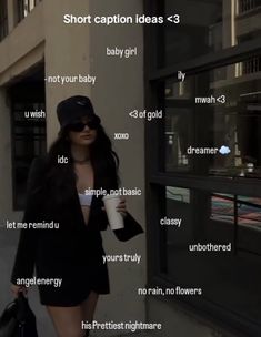 a woman walking down the street holding a coffee cup and wearing a black hat with her name written on it