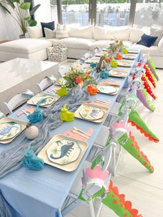 a long table set with plates and place settings for an ocean themed birthday party or baby shower