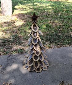 a tree made out of cardboard sitting on top of a sidewalk