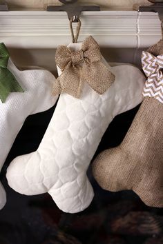 three stockings hanging on a clothes line with burlocks and bow ties attached to them