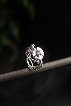 ITEM DESCRIPTION: The size of ring 7 (US and Canada) O (UK and AU) I can make it any size you want - just mark your size in the order Weight - 2,5 g. I made this botanical ring of sterling silver and garnet. I placed a highly detailed poppy flower in the center. And the leaves are located on the sides of it. I can make it with different gemstones - write to me and will discuss your custom order. I usually respond to letters very quickly. This Elven ring will be a great addition to your jewelry c Flower Shaped Birthstone Promise Ring, Nature-inspired Flower Wedding Rings, Adjustable Flower Crystal Ring, Nature-inspired Flower Promise Ring, Nature-inspired Round Flower Ring For Anniversary, Flower Shaped Promise Ring With Flower Charm, Nature-inspired Flower Ring With Birth Flower Detail, Heirloom Flower Ring Gift, Heirloom Flower Ring For A Gift