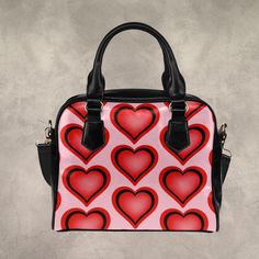 Black PU leather shoulder handbag in white, black, or pink featuring a pattern of red and black colored hearts. This Faux leather purse has a beautiful heart pattern on both sides and plenty of room inside for personal items.   * Designed for a stylish fashion statement. * Made from high-grade PU leather. * Lined interior features backwall zippered, large capacity. * Double PU leather handles, removable and adjustable fabric shoulder strap. * Single zippered top closure. Dimensions:9.45"(L) x 3. Background Cute, Black Leather Handbag, Faux Leather Purse, Leather Shoulder Handbags, Black Leather Handbags, How To Make Handbags, Red Hearts, Black Accents, Colorful Heart