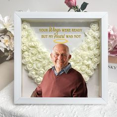 an old man is sitting in front of a white frame with roses on it and the words, your wings were ready but my heart was not