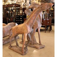 two giraffes are standing next to each other in a room filled with antiques