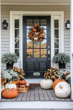 front porch decorated for fall with pumpkins and gourds