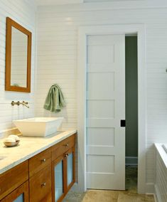 a bathroom with two sinks and a large mirror on the wall next to a bathtub