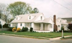 a white house sitting on the corner of a street