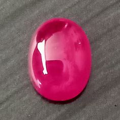 a pink object sitting on top of a gray surface