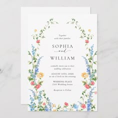 a wedding card with watercolor flowers on it