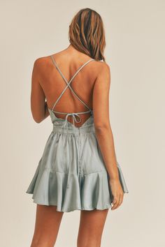 This is a lovely ruffle romper with back lace-up details and an invisible zipper at the back. For a summer outfit, pair it with a summer bag from our eco-friendly collection and flat sandals. Wear a stunning gown to draw attention to your hourglass figure. Your captivating beauty will captivate people. This backless smocked mini dress goes with everything for an effortlessly chic look. It's the ideal addition to your spring wardrobe. This cute silk print midi dress is made of 100% polyester. The Backless Sundress With Ruffle Hem, Summer Sundress With Lace-up Back, Backless Dress With Ruffle Hem For Garden Party, Spring Sundress With Lace-up Back And Spaghetti Straps, Sundress With Corset Back For Day Out, Flirty Spring Dress With Bow Tie Back, Summer Dresses With Corset Back And Cross Back, Flirty Bow Tie Back Dresses For Spring, Summer Backless Dress With Ruffle Hem