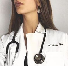 a woman wearing a white coat and stethoscope