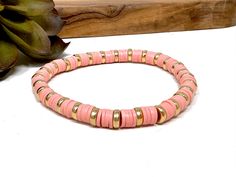 Handmade item * Materials * ----------------- 6x2mm Clay Heishi Beads * Dimensions * -------------------- Length:  7"  Width:  .25" * Details * ------------- Feminine stretch bracelet made with thin clay heishi beads in a dusty rose pink separated by plastic gold beads strung on stretchy bead cord.  Bracelet can be worn separately or stacked with your other favorites.  Keep up to date with new products by following me on social media  Instagram: @UtterlyAccessorized Facebook: UtterlyAccessorized Clay Bead Bracelets, Dusty Rose Pink, Clay Bead, Cord Bracelet, Bead Bracelets, Heishi Beads, Bead Stringing, Clay Beads, Stretch Bracelet