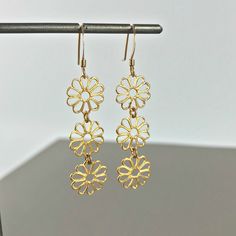 "Flower Earrings Linear Earrings Drop Earrings Dangle Earrings Bohemian Earrings Filigree Earrings Dainty Earrings Lace Earrings Gift for her These beautiful linear lightweight Daisy earrings have a delicate blend of femininity and edge. Light enough for every day yet filled with elegant beauty for your special occasions. Material: Gold Plated Brass / Silver Plated Brass Length - 2\" Width: 6/16' Earring Backings: Each pair of earrings includes a set of clear rubber stoppers. All my jewelry come Pierced Metal Drop Flower Earrings, Gold Nickel-free Drop Flower Earrings, Gold Dangle Flower Earrings, Gold Dangle Flower Earrings With Hooks, Brass Dangle Flower Earrings, Adjustable Drop Flower Earrings, Hypoallergenic Gold Drop Flower Earrings, Hypoallergenic Metal Flower-shaped Earrings, Delicate Metal Dangle Earrings