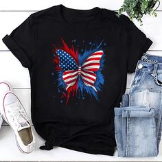 Introducing our Patriotic Butterfly Tee, where the beauty of nature meets national pride in a stunning design. This eye-catching t-shirt features an illustration of a butterfly adorned in the vibrant colors of the American flag, capturing the spirit of freedom, strength, and unity. Perfect for those who love to showcase their patriotic spirit in a unique and artistic way. Crafted with meticulous attention to detail, our Patriotic Butterfly Tee offers both style and comfort. Made from premium, so Patriotic Multicolor Short Sleeve T-shirt, Black T-shirt With American Flag For 4th Of July, Black Flag Print Top For Summer, Black Tops With Flag Print For Summer, Multicolor Flag Print Casual T-shirt, Black Tops With American Flag Print For Summer, Black Summer Top With American Flag Print, Patriotic Black Top With Flag Print, Patriotic Crew Neck T-shirt For Spring