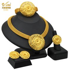 This exquisitely designed and luxurious set will add the perfect touch of opulence and magnificence to any outfit. Gold-plated, and made of 24k gold, it makes an excellent gift for someone you care about. — Get this eye-catching, designer 24K gold necklace, earrings, and bracelet set for your loved one. It will be a perfect gift for a birthday or an anniversary. Specifications: Style: TRENDY Shape: PLANT Plating: Silver Plated Occasion: Wedding Occasion: Parties Metals Type: Gold Plated Material: Gold Type: Bridal Jewelry Sets Item Type: Jewelry Sets Elegant Gold Plated Bridal Sets For Anniversary, Luxury Round Bridal Sets Gift, Gold Round Jewelry Sets For Anniversary, Elegant Gold Jewelry Set As Gift, Gold Plated Bridal Sets Gift, Gold Plated Round Bridal Sets As Gift, Elegant Formal Sets With Intricate Design, Elegant Gold Plated Round Bridal Sets, Gold Bridal Sets Gift