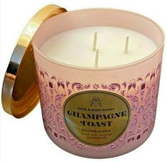 a pink candle with gold trim around it