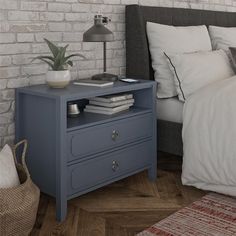 a bed room with a neatly made bed and a night stand next to the bed