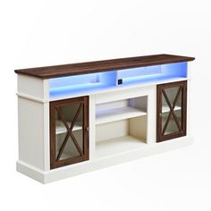 a white entertainment center with blue lights on the top and doors open to reveal an entertainment center