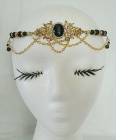 "This beautiful circlet has black glass beads, gold plated accent beads, gold plated chain, brass side accent pieces, brass pendant and black cats eye stone setting with rhinestones. 20\" long can be adjusted to 24\". Lobster clasp." Adjustable Metal Body Jewelry For Evening, Antique Black Jewelry For Ceremonial Occasions, Antique Black Ceremonial Jewelry, Elegant Adjustable Jeweled Body Jewelry, Elegant Ceremonial Crown Headpieces, Elegant Adjustable Body Jewelry For Festivals, Gold Jeweled Crown Jewelry, Vintage Black Ceremonial Jewelry, Gold Ceremonial Headpiece With Round Crown