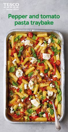 a pan filled with pasta and vegetables on top of a table