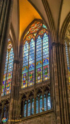 the inside of a cathedral with stained glass windows