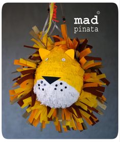 a paper mache lion ornament hanging from a string with the words mad pinata on it