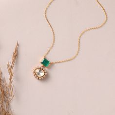 Description: Embrace timeless elegance with our delicate Pendant Necklace, featuring a captivating green cushion-cut semi-precious stone at its core. Dangling below is a shimmering moissanite, elegantly encircled by a CZ halo. This pendant necklace effortlessly captures attention, radiating a delicate grace that elevates your overall look with its timeless beauty. Product Information Metal: 925 Silver with 1.0 microns Gold Plating Length: 23cm Stones: Semi precious stones Findings: Hook & links Green Diamond Necklace With Halo Setting, Elegant Green Solitaire Necklace For May Birthstone, Elegant Green Solitaire Necklace, Green Emerald Necklace With Halo Setting For May Birthstone, May Birthstone Green Emerald Necklace With Halo Setting, May Birthstone Emerald Necklace With Halo Setting, Green Necklace With Halo Setting For Wedding, Elegant Green Round Solitaire Necklace, Green Halo Setting Necklace For Wedding