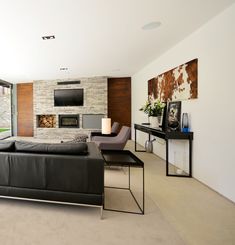 a living room with couches and a table in front of a large glass window