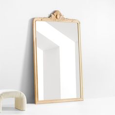 a mirror sitting on top of a white counter next to a stuffed animal and pillow