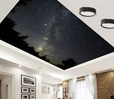 a living room filled with furniture under a night sky