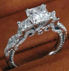 an engagement ring with three princess cut diamonds