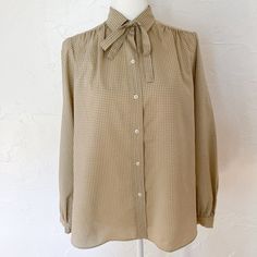 "Cute, minimal, career blouse from the 80s. Beige with tiny black and white linear pattern. Long sleeves, collared with necktie. Cream buttons down the front and on cuffs. Curved hem on the sides. Excellent vintage condition, no flaws to note. Made by Evan-Picone. 100% polyester. Feels silky. Best for a medium to large. Exact measurements are: 15\" Across Shoulders 40\" Bust 22\" Sleeves 44\" Waist 28\" Length" Black White Abstract, Linear Pattern, Black And White Abstract, The 80s, Womens Clothing Tops, Neck Tie, Blouses For Women, Blouses, Long Sleeves