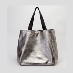 Metallic leather bag handmade in our atelier with premium metallic leather. This large-size bag (available in two sizes, large and extra-large versions, see options) has reinforced leather handles for wearing it on the shoulder or by hand.  It's a trendy silver leather tote bag with the magic touch of metallic leather.  Top closure by two leather straps and one magnetic clasp. The soft leather allows the bag to take different shapes. On the shoulder or by hand is always a stylish purse.   Availa Silver Tote Bag, Metallic Leather Bag, Waist Bag Leather, Soft Leather Tote, Soft Leather Handbags, Slouchy Bag, Large Leather Tote Bag, Silver Bags, Stylish Purse