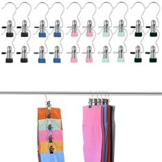 several pairs of colorful pants hanging from hooks on a clothes line with clips attached to them