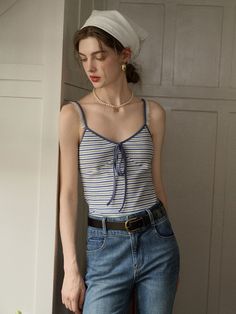 a woman wearing jeans and a tank top