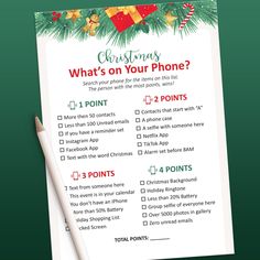 a christmas wish list with a pen on top of it and a sheet of paper next to it that says, what's on your phone?