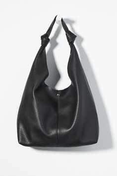 This oversized tote is your new BFF. Tied with two playful knots, this just-right sized, slouchy silhouette is designed to hold all your essentials (and more!) effortlessly – and with a touch of oh-so-fashionable flair. | The Love Knot Slouchy Bag by Anthropologie in Black, Women's, Polyurethane Slouchy Bag, Faux Leather Bag, Love Knot, Leather Bag, Knot, Anthropologie, Black Leather, Faux Leather, Leather