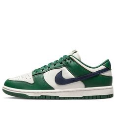 The Nike Dunk Low 'Gorge Green' is a stylish sneaker for women that features a unique colorway of Gorge Green, Midnight Navy, and Phantom. The upper is made of leather with a mesh tongue and lining. It sits atop a Phantom midsole with a green overlay and double-colored rubber outsole with Midnight Navy Swooshes. This sneaker is perfect for a variety of activities, from running errands to hitting the gym. The design is inspired by the classic Nike Dunk series, making it a must-have for any sneaker enthusiast. (SNKR/Skate/Low Top/Women's/Non-Slip/Wear-resistant/Shock-absorbing) Green Skate Shoes With Boost Midsole For Streetwear, Green Low-top Basketball Shoes With Gum Sole, Green Custom Sneakers With Contrast Sole For Streetwear, Low-top Green Basketball Shoes With Gum Sole, Casual Green Basketball Shoes With Gum Sole, Green Mid-top Sneakers With Boost Midsole, Urban Green High-top Sneakers With Boost Midsole, Green Low-top Custom Sneakers For Skateboarding, Green Mid-top Sneakers For Streetwear