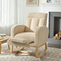 a beige rocking chair sitting in front of a fire place