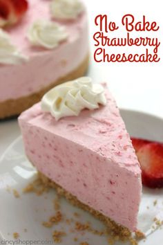 two slices of strawberry cheesecake with whipped cream on top and strawberries in the background