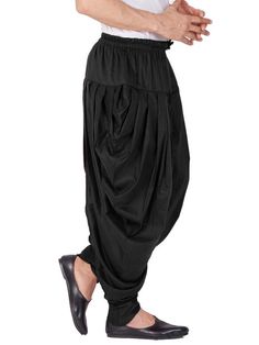 Vastramay brings to you this Stylish yet Comfortable Men Black Men Cotton Art Silk Cowl Design Patiala Style Dhoti Pant. Adorn it for a perfect Classy and Trendy look. Pair it with a juti or a mojari for the Royal look. Product Features :  Top Color: Black Bottom Color: Black Top Fabric: Cotton Art Silk Bottom Fabric: Cotton Art Silk Blend Product Type: Cowl Design Patiala Style Dhoti Pant Fabric Purity: Blended Weave Pattern: Regular Traditional Harem Pants For Navratri, Traditional Black Harem Pants For Yoga, Traditional Ankle-length Bottoms For Diwali, Bollywood Style Harem Bottoms For Festivals, Traditional Fitted Pants For Festivals, Traditional Fitted Bottoms For Eid, Fitted Harem Pants For Festivals, Traditional Fitted Bottoms For Navratri, Traditional Ankle-length Harem Pants For Festivals