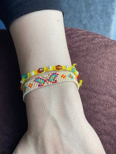 a person wearing a bracelet with beads on their wrist