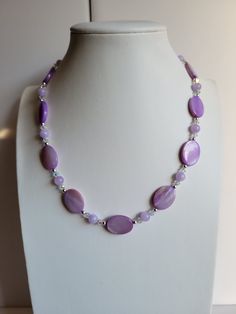 "The oval Mother-of-Pearl beads in this necklace are light purple. It has clear ab Swarovski crystal beads and Purple Galaxie Jade. The findings and remaining beads are sterling silver. It is 17.5\" long and has a 1\" extension with a beaded drop making it adjustable. Custom Orders are always welcome!" Lavender Single Strand Round Bead Jewelry, Purple Pearl Single Strand Jewelry, Lavender Single Strand Jewelry With Round Beads, Purple Single Strand Pearl Jewelry, Purple Pearl Necklaces With Round Beads, Purple Oval Beaded Necklaces For Jewelry Making, Purple Pearl Single Strand Necklace, Adjustable Purple Pearl Necklace With Round Beads, Purple Beaded Oval Jewelry