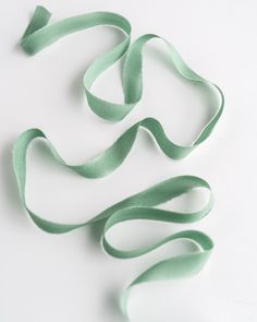 green ribbon on white background with no image in the top right corner and bottom left corner