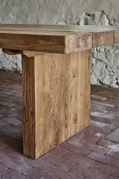 a wooden bench sitting on top of a brick floor