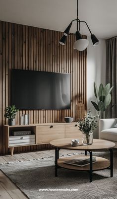 a living room with wood paneling and a flat screen tv mounted on the wall