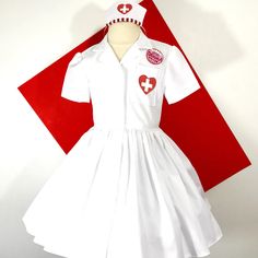 White Nurses uniform shirt Dress with heart cross pocket detail and hat. This dress is shown with an underskirt that can be purchased in my shop for an additional $10. https://www.etsy.com/listing/116097306/tulle-underskirt-made-to-order?ref=shop_home_active Thank you for checking out my listing! Nurse Dress Uniform, Baby Girls Dresses, Tulle Underskirt, Cowgirl Dresses, Uniform Shirt, Flamingo Shirt, Uniform Dress, Corpus Christi Tx, Uniform Shirts