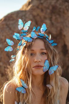 a woman with blue butterflies on her head