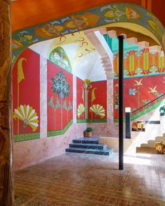 an artisticly painted room with stairs and steps leading up to the second floor area